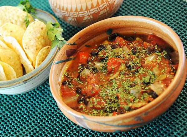 Black bean soup dusted with cilantro, served with tortilla chips on the side. (Lake Fong/Pittsburgh Post-Gazette/TNS)