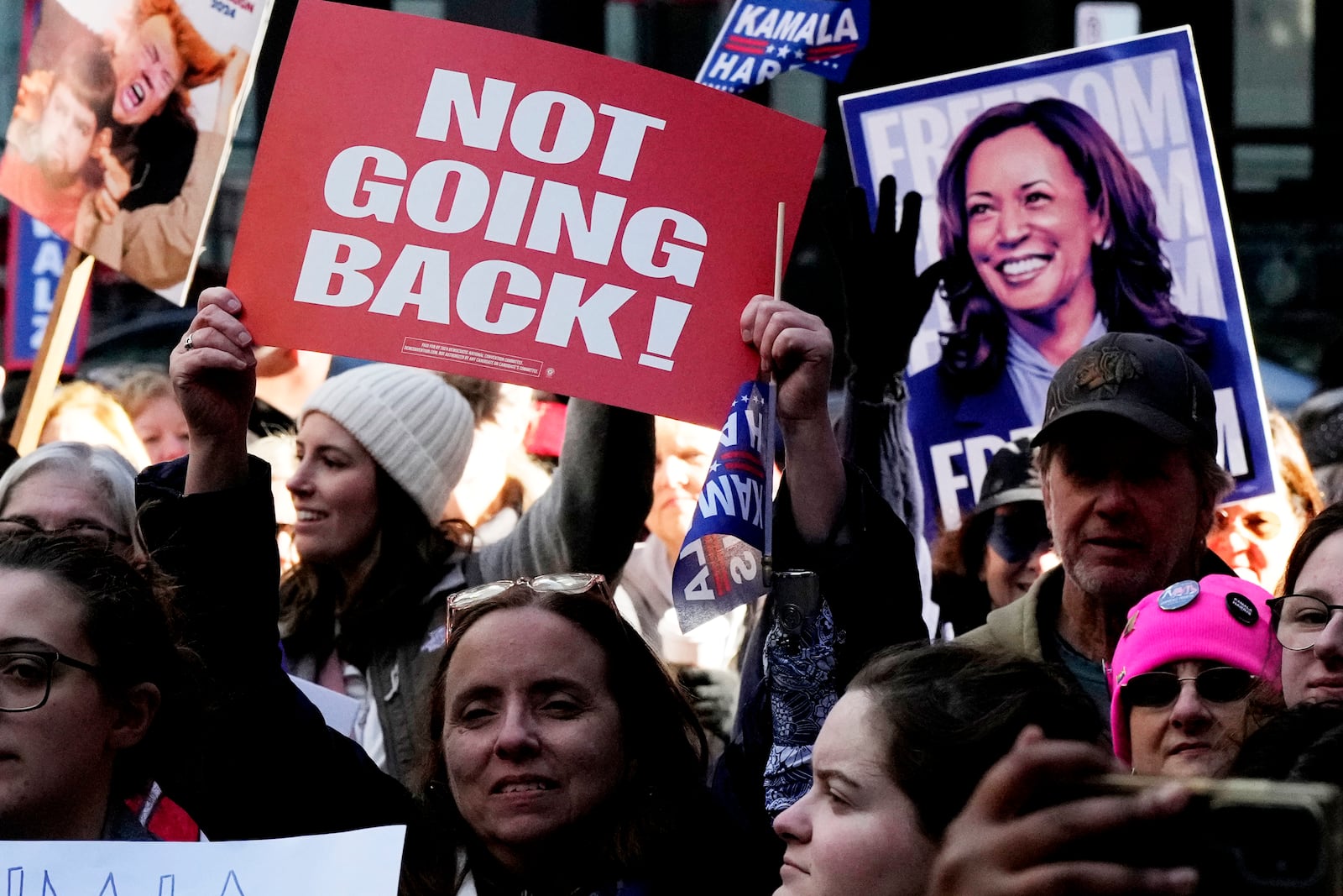 Women hold signs as they attend National Women's March in Chicago, Saturday, Nov. 2, 2024. The Women's March movement launched the day after Donald Trump's inauguration, when hundreds of thousands of women poured into the District and across the country in what is widely considered the largest single-day protest in American history. (AP Photo/Nam Y. Huh)