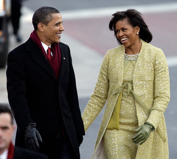 President Barack Obama walks down Pennsylvania Avenue with his wife Michelle Obama on their way to the White House in Washington on Jan. 20, 2009.