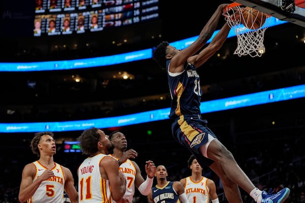 New Orleans Pelicans center Yves Missi (21) dunks against the Atlanta Hawks during the first half of an NBA basketball game, Monday, Dec. 2, 2024, in Atlanta. (AP Photo/Mike Stewart)