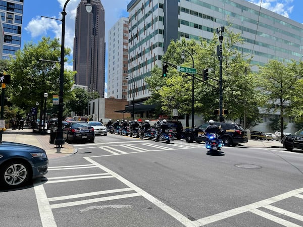 Several blocks of Peachtree Street are blocked Wednesday after an officer was shot at an apartment building. There is a heavy police presence in the area.