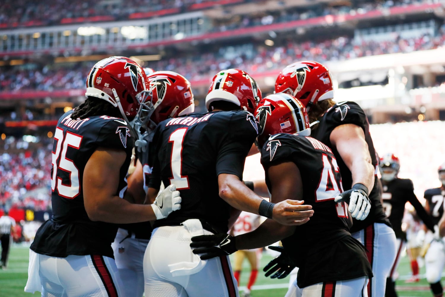 Falcons teammates celebrate with quarterback Marcus Mariota (1) after he scored a touchdown against the 49ers on Sunday in Atlanta. (Miguel Martinez / miguel.martinezjimenez@ajc.com)