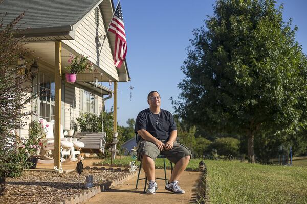 On her release from Henry County’s jail, Tiffany Callahan was issued a pre-paid debit card holding the money she went in with. The cards charge fees for transactions. ‘I don’t agree with the fees,’ says Callahan. ‘It’s my money that I saved up.’ Callahan sits outside her home in Locust Grove. ALYSSA POINTER / ALYSSA.POINTER@AJC.COM