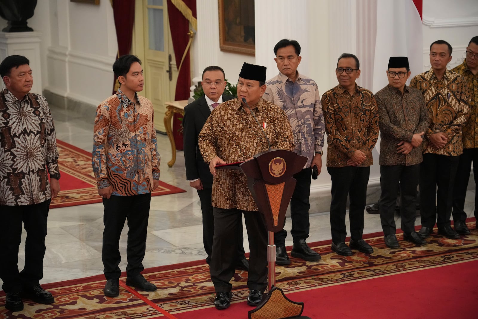 Indonesia's new President Prabowo Subianto, center, announces his cabinet lineup of newly-appointed ministers, at Merdeka Palace in Jakarta, Indonesia, Sunday, Oct. 20, 2024. (AP Photo/Achmad Ibrahim)