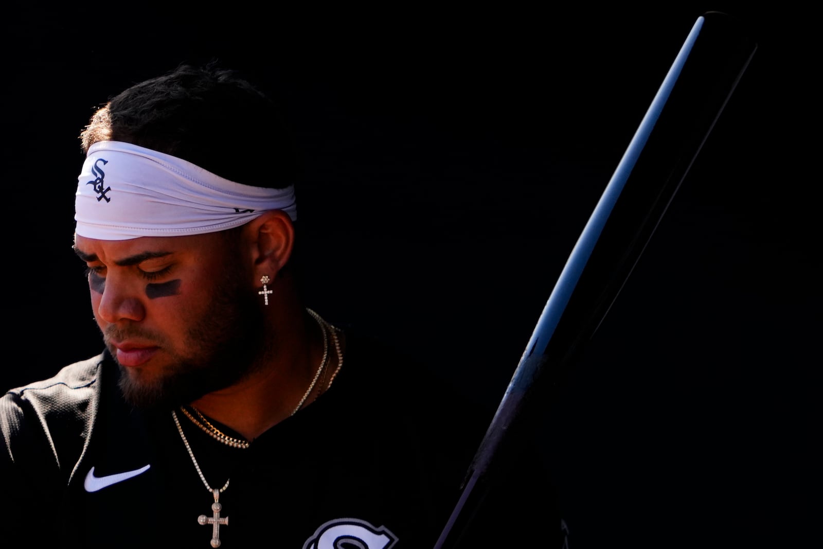 FILE - Chicago White Sox's Yoan Moncada holds a bat in the dugout before a spring training baseball game against the San Diego Padres, March 9, 2024, in Peoria, Ariz. (AP Photo/Lindsey Wasson, File)