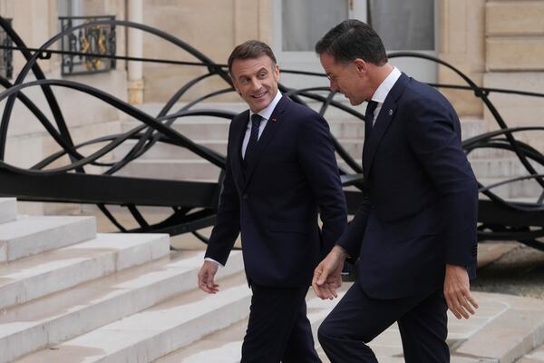 France's President Emmanuel Macron, left, welcomes NATO Secretary General Mark Rutte prior to a meeting at the Elysee Palace, in Paris, France, Tuesday, Nov. 12, 2024. (AP Photo/Michel Euler)