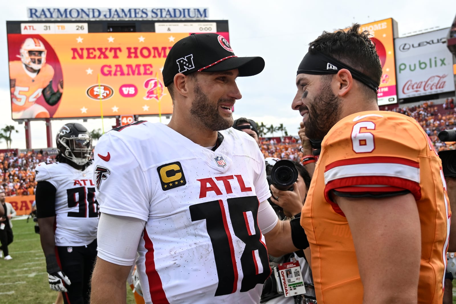 Atlanta Falcons quarterback Kirk Cousins (18) speaks to Tampa Bay Buccaneers quarterback Baker Mayfield (6) after an NFL football game, Sunday, Oct. 27, 2024, in Tampa. The Atlanta Falcons won 31-26. (AP Photo/Jason Behnken)