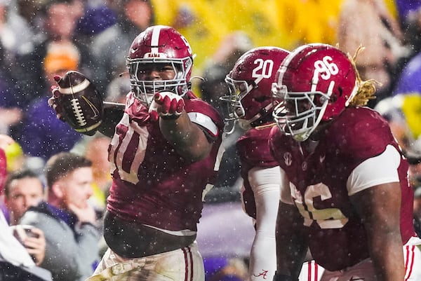 Alabama defensive lineman Tim Smith (50) celebrates after recovering a fumble by LSU quarterback Garrett Nussmeier in the first half an NCAA college football game in Baton Rouge, La., Saturday, Nov. 9, 2024. (AP Photo/Gerald Herbert)