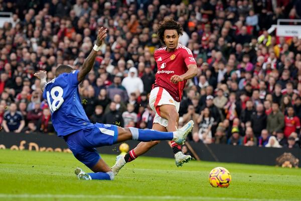 Manchester United's Joshua Zirkzee, right, challenged by Everton's Ashley Young scores during the English Premier League soccer match between Manchester United and Everton at the Old Trafford stadium in Manchester, England, Sunday, Dec. 1, 2024. (AP Photo/Dave Thompson)