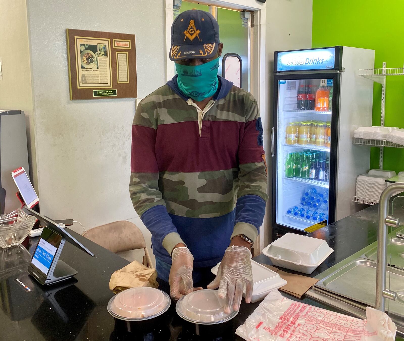 Toyin co-owner Abdul Kokumo prepares a takeout order. Wendell Brock for The Atlanta Journal-Constitution