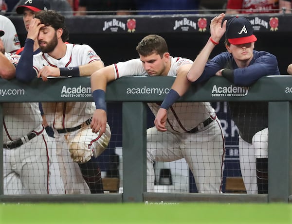 Braves players (from left) Dansby Swanson, Austin Riley, and Max Fried react in the dugout during the final three outs against the Washington Nationals.    “Curtis Compton / Curtis.Compton@ajc.com”