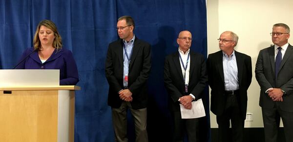 Alaska Air Group spokeswoman Bobbie Egan introduced Alaska president and CEO Brad Tilden, Horizon Air president and CEO Gary Beck, Port of Seattle operations director Mike Ehl and FBI special-agent-in-charge Jay Tabb at a news conference at Sea-Tac International Airport on Saturday, Aug. 11, 2018. (Daniel Beekman/Seattle Times/TNS)