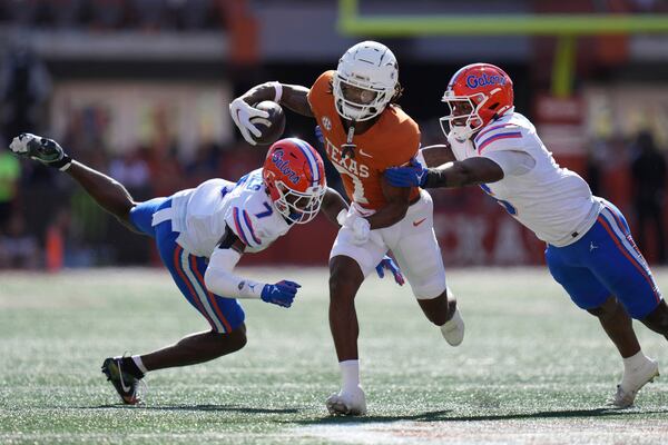 Texas wide receiver Isaiah Bond (7) runs for a touchdown past Florida defenders Trikweze Bridges (7) and Shemar James (6) during the second half of an NCAA college football game in Austin, Texas, Saturday, Nov. 9, 2024. (AP Photo/Eric Gay)