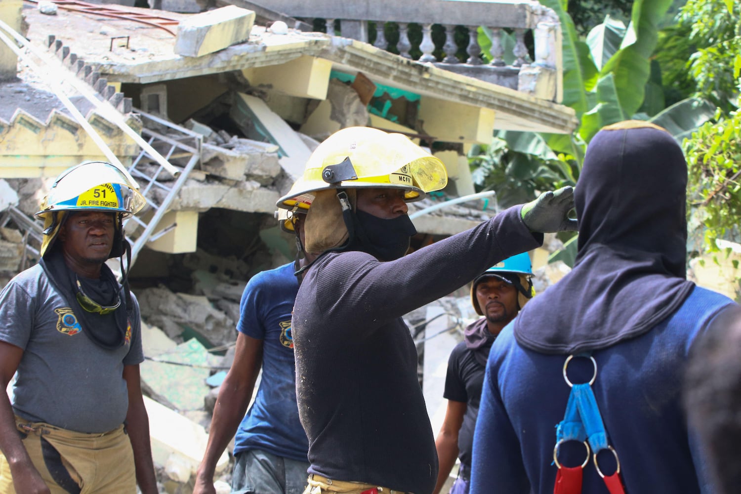 Rescue workers search through destroyed buildings in Les Cayes, Haiti on August 15, 2021, after a 7.2-magnitude earthquake struck the southwest peninsula of the country. STANLEY LOUIS/Getty Images