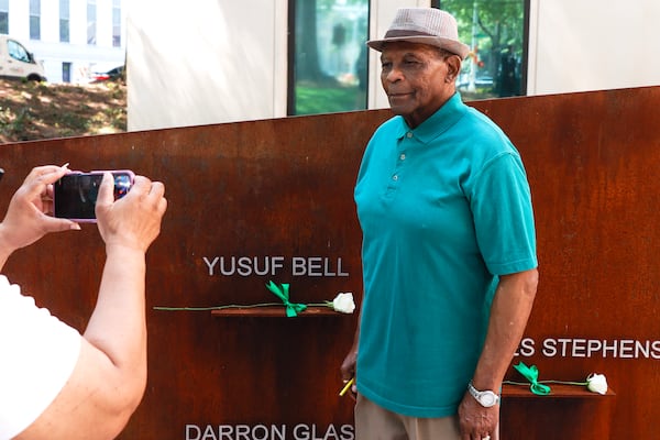 John Bell, the father of victim Yusef Bell takes a photo next to his son’s name at the Atlanta Children’s Eternal Flame Memorial on Tuesday June 27, 2023. The memorial was created to honor the lives of children killed during the Atlanta Child Murders. (Natrice Miller/ Natrice.miller@ajc.com)