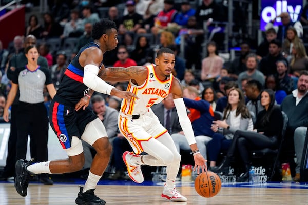 Atlanta Hawks guard Dejounte Murray (5) drives as Detroit Pistons guard Hamidou Diallo (6) defends during the first half of an NBA basketball game, Wednesday, Oct. 26, 2022, in Detroit. (AP Photo/Carlos Osorio)