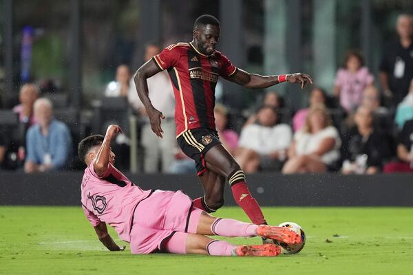 Inter Miami midfielder Tomás Aviles (6) blocks a pass by Atlanta United forward Jamal Thiaré (29) during the second half of their MLS playoff opening round soccer match, Saturday, Nov. 9, 2024, in Fort Lauderdale, Fla. (AP Photo/Rebecca Blackwell)