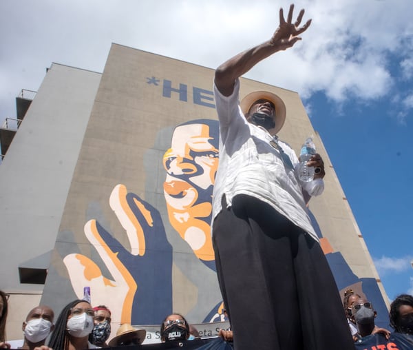 The Rev. Gerald Durley speaks in front of the John Lewis mural during the March On For Voting Rights walk in Atlanta on Saturday, August 28, 2021. STEVE SCHAEFER FOR THE ATLANTA JOURNAL-CONSTITUTION