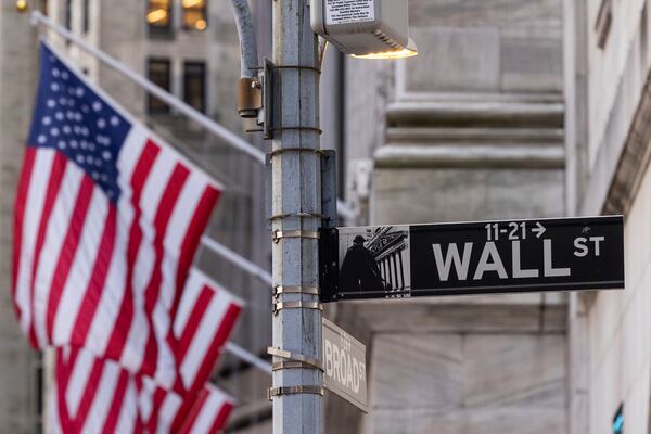 FILE - Wall Street sign is seen outside the New York Stock Exchange, Thursday, March. 21, 2024. Reddit shares will begin trading Thursday. (AP Photo/Yuki Iwamura, File)