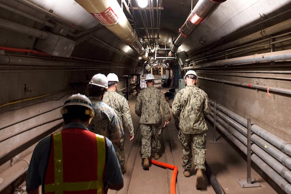 FILE - In this photo provided by the U.S. Navy, Rear Adm. John Korka, Commander, Naval Facilities Engineering Systems Command (NAVFAC), and Chief of Civil Engineers, leads Navy and civilian water quality recovery experts through the tunnels of the Red Hill Bulk Fuel Storage Facility, near Pearl Harbor, Hawaii, on Dec. 23, 2021. (Mass Communication Specialist 1st Class Luke McCall/U.S. Navy via AP, File)