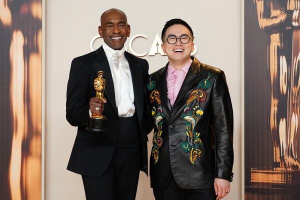 Paul Tazewell, left, winner of the award for best costume design for "Wicked," poses in the press room with Bowen Yang at the Oscars on Sunday, March 2, 2025, at the Dolby Theatre in Los Angeles. (Photo by Jordan Strauss/Invision/AP)