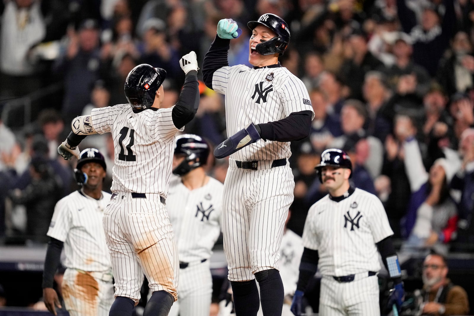 New York Yankees' Anthony Volpe celebrates his grand slam home run with Aaron Judge against the Los Angeles Dodgers during the third inning in Game 4 of the baseball World Series, Tuesday, Oct. 29, 2024, in New York. (AP Photo/Ashley Landis)