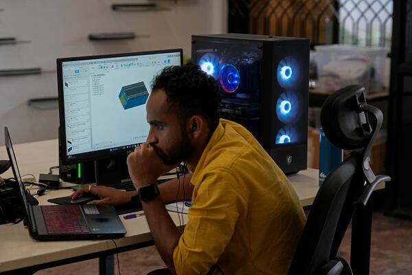 Venkatesh Sankaramanchi, a battery design engineer at Nunam, works on new designs for refurbished battery packs, at their facility in Bengaluru, India, Tuesday, Oct. 8, 2024. (AP Photo/Aijaz Rahi)