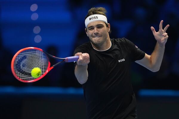 United States' Taylor Fritz returns the ball to Italy's Jannik Sinner during their singles tennis match of the ATP World Tour Finals at the Inalpi Arena, in Turin, Italy, Tuesday, Nov. 12, 2024. (AP Photo/Antonio Calanni)