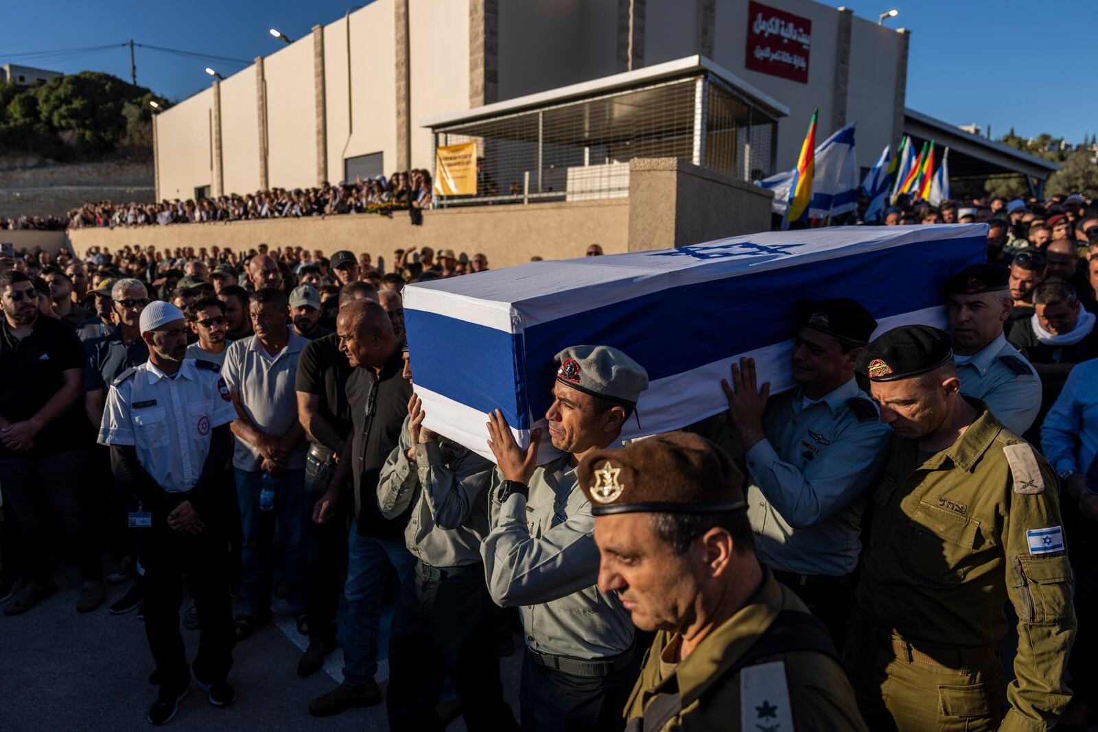 Israeli soldiers carry the flagged-covered coffin of Israeli Druze Colonel Ehsan Daxa, in Daliyat al-Carmel, Israel, Monday, Oct. 21, 2024. Daxa, 41, was killed during Israel's ground operation in the Gaza Strip, where the Israeli army has been battling Palestinian militants in the war ignited by Hamas' Oct. 7 2023 attack into Israel. (AP Photo/Ariel Schalit)