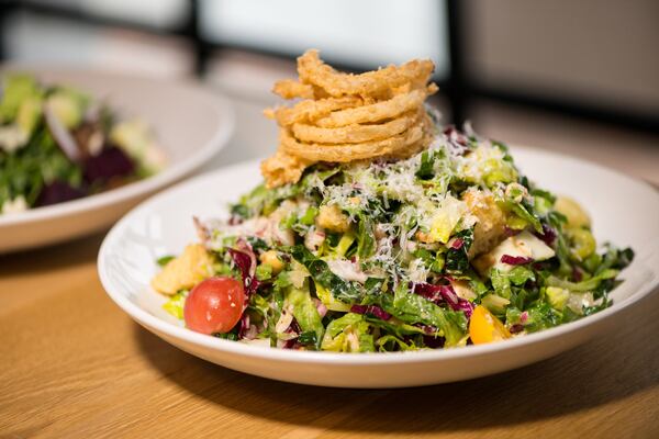  Howell's Chopped Salad with chopped greens, smoked turkey, salami, fontinella, garbanzo beans, olives, pepperoncini, tomato, brioche croutons, crispy onion, and red wine vinaigrette. Photo credit- Mia Yakel.