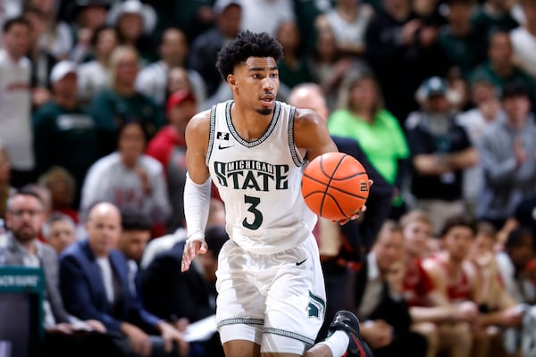 Michigan State guard Jaden Akins pushes the ball upcourt during the second half of an NCAA college basketball game against Wisconsin, Sunday, March 2, 2025, in East Lansing, Mich. (AP Photo/Al Goldis)