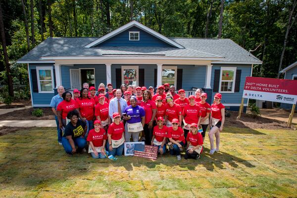 Delta Air Lines employees and members of Habitat for Humanity Atlanta dedicate a home in southeast Atlanta on Friday, Sept. 21, 2018