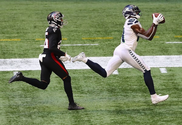 Seahawks wide receiver D.K. Metcalf catches a touchdown pass past Atlanta Falcons cornerback Isaiah Oliver for a 21- 12 lead during the third quarter Sunday, Sept. 13, 2020, in Atlanta.  (Curtis Compton / Curtis.Compton@ajc.com)