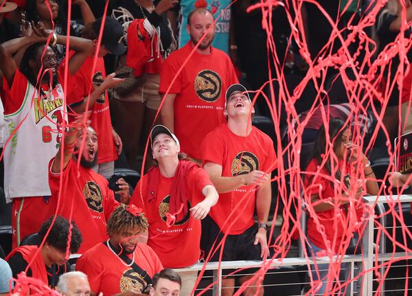 062921 Atlanta: Confetti falls from the ceiling as Atlanta Hawks fans celebrate a 110-88 victory over the Milwaukee Bucks during the fourth quarter in game 4 of the NBA Eastern Conference Finals on Tuesday, June 29, 2021, in Atlanta.   “Curtis Compton / Curtis.Compton@ajc.com”