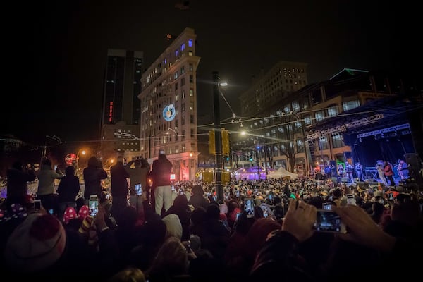 People celebrate as 2018 arrives with the Peach Drop 2017 at Wooddruff Park, Dec. 31, 2017, in Atlanta. BRANDEN CAMP / SPECIAL