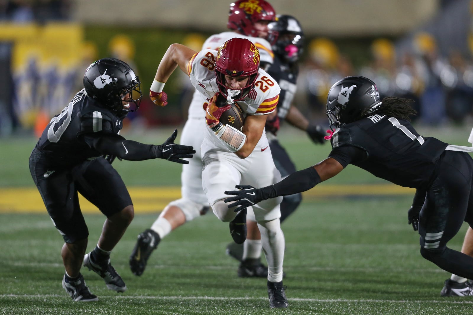 Iowa State running back Carson Hansen (26) rushes the ball against the West Virginia during the first half of an NCAA college football game, Saturday, Oct. 12, 2024, in Morgantown, W.Va. (AP Photo/William Wotring)