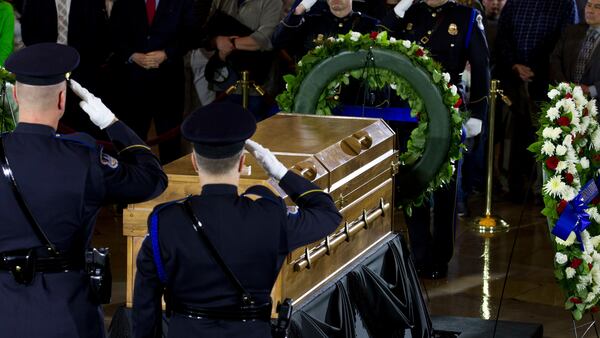 Visitors pay their respects as the casket of Reverend Billy Graham lies in honor at the Rotunda of the U.S. Capitol Building in Washington, Wednesday, Feb. 28, 2018. It's a rare honor for a private citizen to lie in honor at the Capitol. Graham died Wednesday in his sleep at his North Carolina home. He was 99. (AP Photo/Jose Luis Magana)