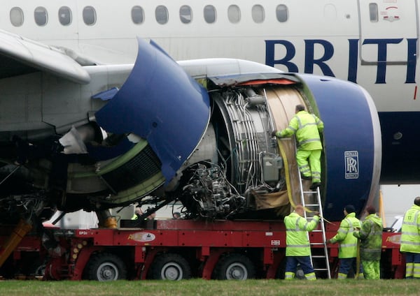 FILE - Workers prepare to recover the British Airways plane which crash-landed, on Thursday, short of the runway at Heathrow Airport, London, Sunday, Jan. 20, 2008. (AP Photo/Sang Tan, File)