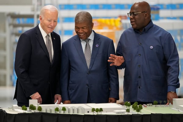 President Joe Biden, accompanied by Angola's President Joao Lourenco, center, and Guinea-Bissau's President Umaro Sissoco Embalo, visits the Carrinho food processing factory near Lobito, Angola on Wednesday, Dec. 4, 2024. (AP Photo/Ben Curtis)