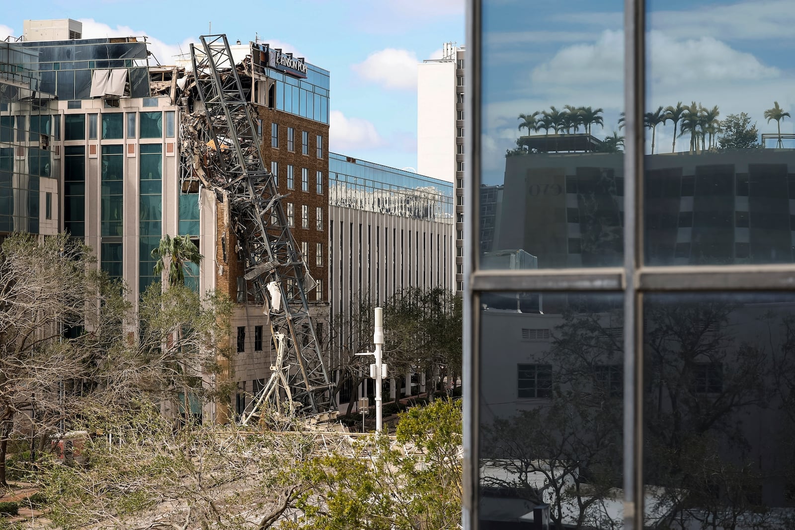 A high-rise construction crane broke apart and crashed into the building across the street during Hurricane Milton on Thursday, Oct. 10, 2024, in St. Petersburg, Fla. (AP Photo/Mike Carlson)