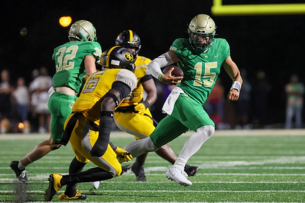 Buford quarterback Dylan Raiola (15) runs for yards during the second half against St. Frances Academy at Tom Riden Stadium, Friday, August 18, 2023, in Buford, Ga. Buford won 18-0. (Jason Getz / Jason.Getz@ajc.com)