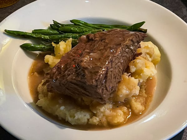 You can get a classic dish of tender beef short rib with mashed potatoes, gravy and green beans at Natalie Bianca. (Henri Hollis/AJC)