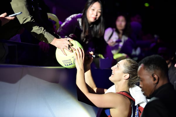 Canada's Gabriela Dabrowski, signs for fans during her women's doubles semi final match against Nicole Melichar-Martinez of the U.S. and Australia's Ellen Perez at King Saud University Indoor Arena, in Riyadh, Saudi Arabia, Friday, Nov. 8, 2024. (AP Photo)