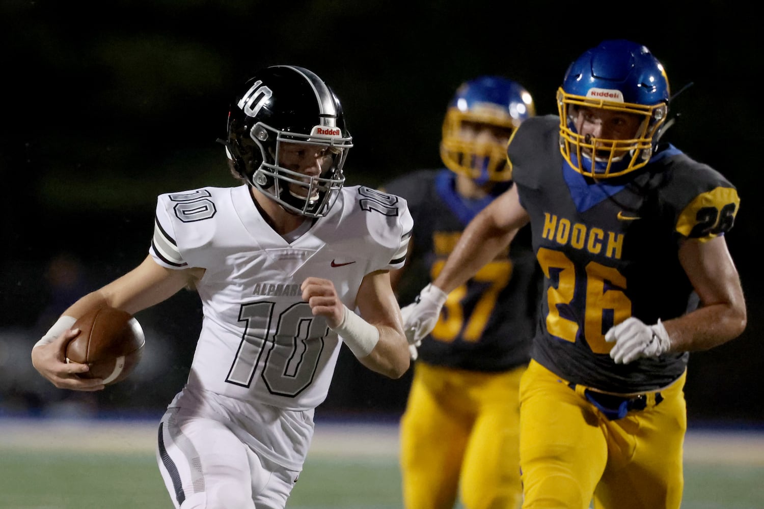 Alpharetta quarterback Ben Guthrie (10) rushes against Chattahoochee linebacker Billy Spradlin (26) in the first half at Chattahoochee high school Friday, September 25, 2020 in Johns Creek, Ga.. JASON GETZ FOR THE ATLANTA JOURNAL-CONSTITUTION