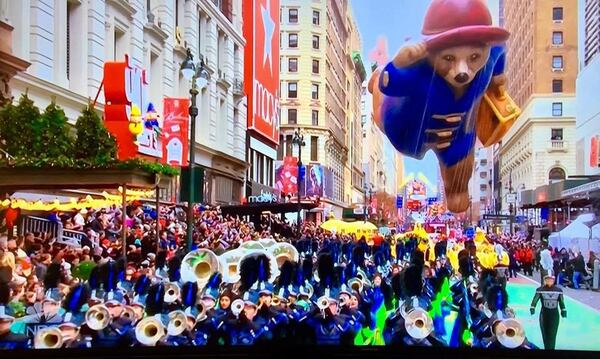 The marching band of Kennesaw’s Harrison High School played the Macy’s Thanksgiving Day Parade Thursday, followed by the giant baloon of Paddington Bear.