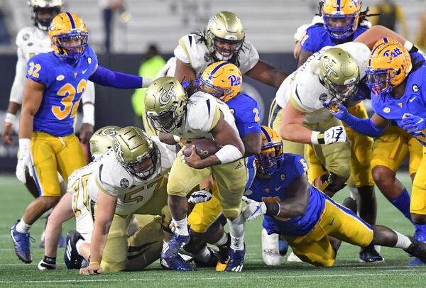 Georgia Tech running back Jordan Mason (27) is stopped by Pittsburgh defensive linemen David Green (2) and Deslin Alexandre (5) during the second half Thursday, Dec. 10, 2020, at Bobby Dodd Stadium in Atlanta.  (Hyosub Shin / Hyosub.Shin@ajc.com)