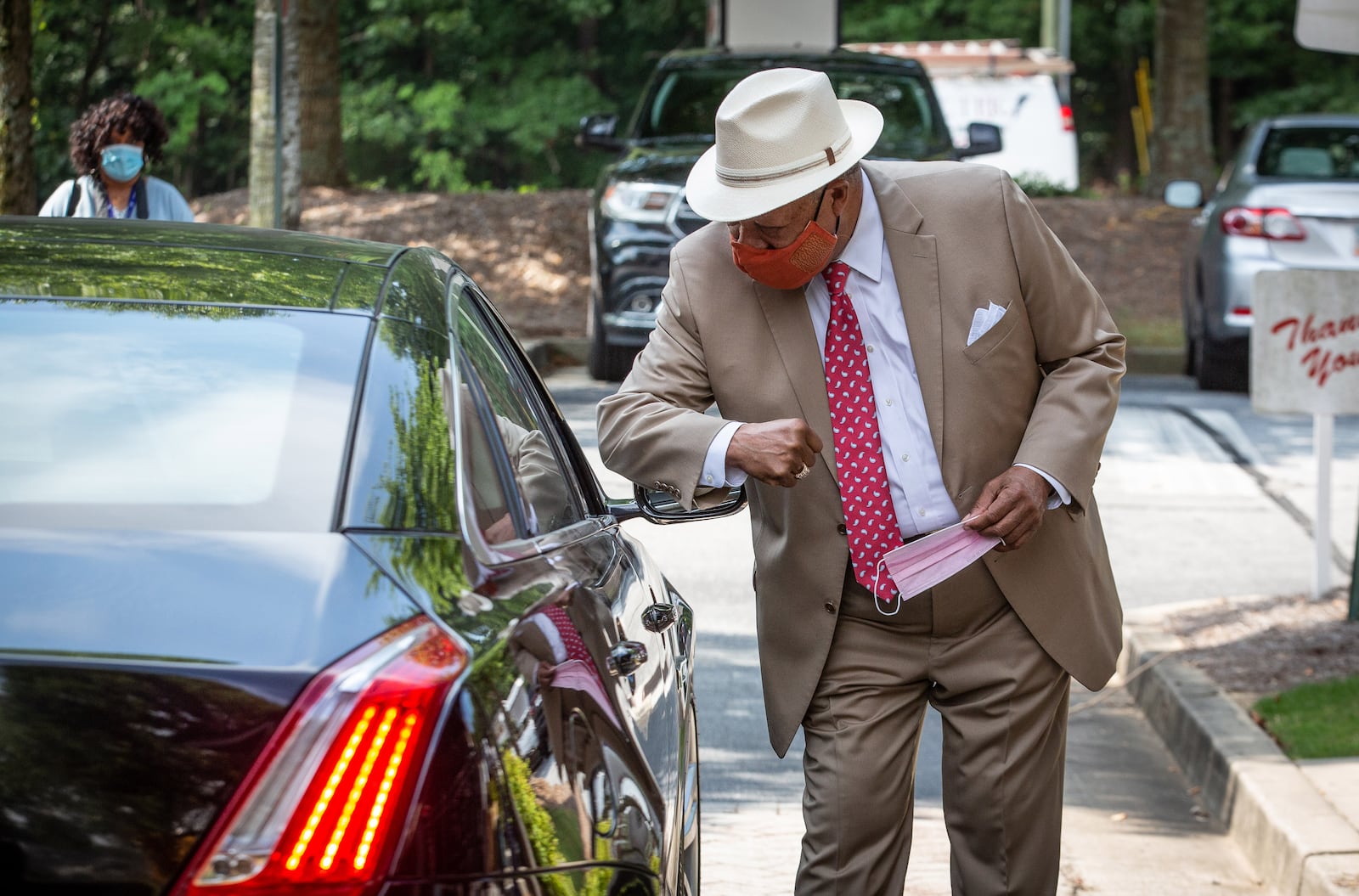 Fulton County Commissioner Robb Pitts gives an Elbow bump to a passenger in a car while distributing PPE to businesses in Atlanta, August 6, 2020.  STEVE SCHAEFER FOR THE ATLANTA JOURNAL-CONSTITUTION