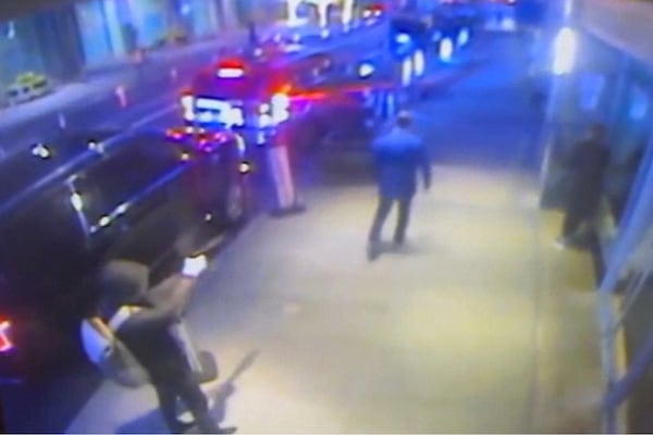 This still image from surveillance video obtained by the Associated Press shows the suspect, left, sought in the the killing of UnitedHealthcare CEO Brian Thompson, center, outside a Manhattan hotel where the health insurer was holding an investor conference, Wednesday, Dec. 4, 2024. (AP Photo)