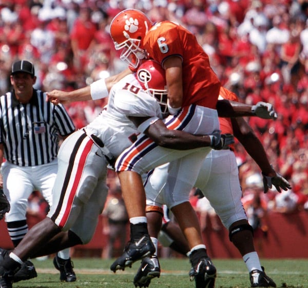 Georgia's Thomas Davis (10) scores a big hit against Clemson's Charlie Whitehurst in the 2003 season opener, Aug. 30, 2003 in Clemson, S.C. (Photo courtesy of UGA Sports Communications)