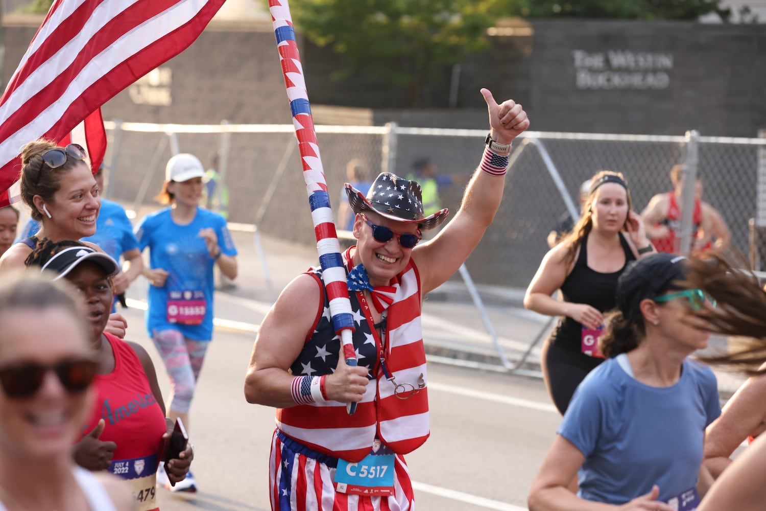 Runners take off at the start of the 53rd running of the Atlanta Journal-Constitution Peachtree Road Race in Atlanta on Monday, July 4, 2022. (Jason Getz / Jason.Getz@ajc.com)